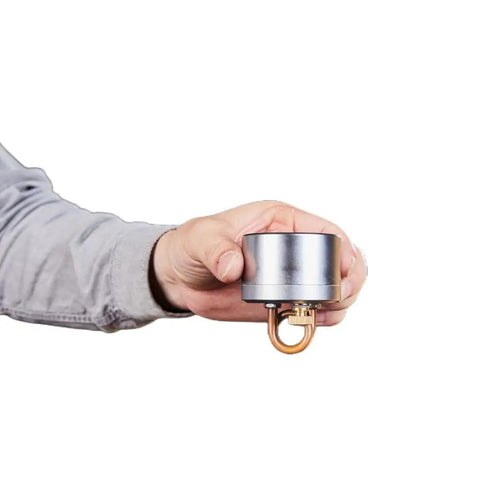 Hand holding Ultra Lite Alcohol Camping Stove With Stand Tiny But Mighty 50ml Denatured Alcohol Burner for Hiking and Backpacking