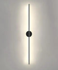 Minimalist Black Linear Wall Sconce - Slim LED Stick Light Fixture for Indoor Use mounted on wall, providing warm illumination.