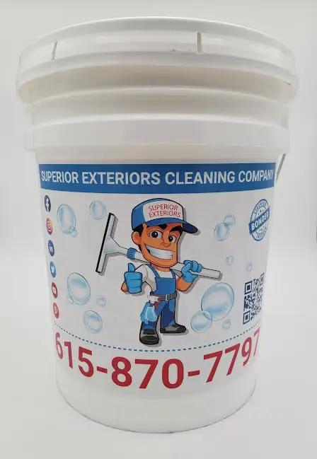White bucket with logo for Superior Exteriors Cleaning Company, featuring a cartoon character and contact info.