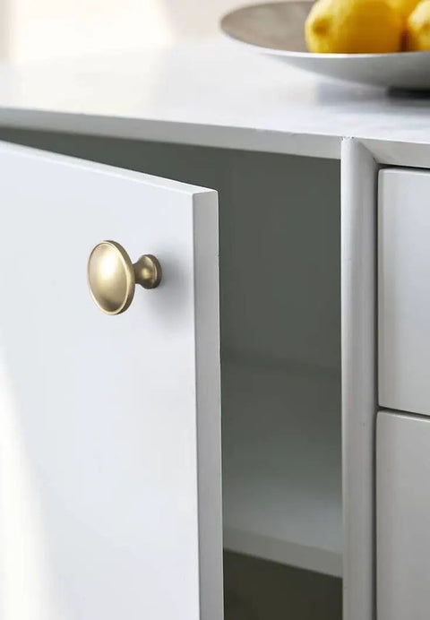 12 Pack Champagne Bronze Cabinet Knobs 1.25 Inch Round Heavy Duty Zinc Alloy Hardware For Kitchen And Bath Cabinets on white door
