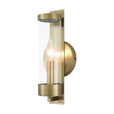 Castleton Antique Brass 1 Light ADA Wall Sconce With Clear Glass Cylinder, classic modern hallway bath lighting, side angle view