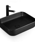 Modern Black Ceramic Vessel Sink For Above Counter Bathroom Vanities rectangular art basin with polished surface and faucet.