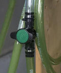 Inline barbed ball valve for 3/4 inch tubing with green knob, installed on translucent green tubing