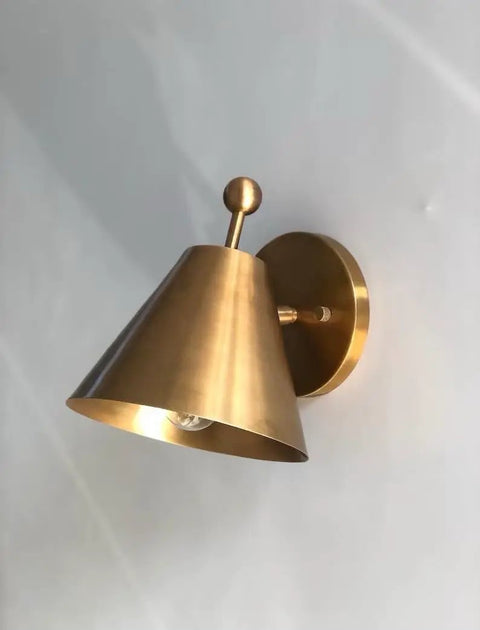 Handcrafted Brass Wall Sconce with Finial Vintage Hardwired Light shown in brass with a cone-shaped shade and decorative finial.