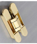 Gold adjustable 180 degree invisible door hinge for folding and hideaway doors mounted on a surface.