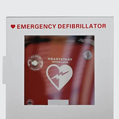 Front view of a white wall-mounted AED cabinet with a red defibrillator inside, labeled Emergency Defibrillator.