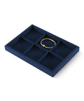 Super Slick Microfiber Jewelry Display Tray With Six Grid Compartments For Ring Earring Bracelet And Necklace Storage Stackable Countertop Organizer Plate Hits Different with a gold ring.