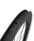 Close-up of Carbon Disc Wheelset 50C-25 Clincher Road Wheels UD Matte Finish Six Bolt showing rim design and spokes.