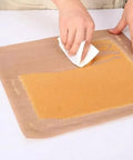 Hands using Five Pack Teflon Baking Sheets 12x16 Inch Nonstick Reusable Liners for kitchen tasks, displaying versatility and ease of use.