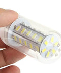 Compact LED light bulb in clear plastic casing held by a hand, showcasing its internal components and design for energy-efficient lighting.