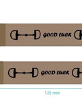 Pair of brown keychains with snaffle bit design, featuring 'Good Luck' text, measuring 125mm x 25mm.