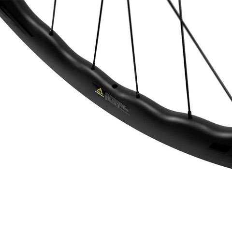 Close-up of Carbon Disc Wheelset With Wave Rim 50CU 25 CC Thru Axle 12x100 for road and gravel bikes, showing 50mm rim depth.