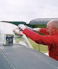 Man polishing airplane windshield with Multipurpose All In One Metal Cleaner And Polish For Chrome Aluminum Silverware Glass And Fiberglass Cleans Shines And Protects All Metals Fiberglass And Acrylics Home And Industrial Use 1000ml Can nearby.