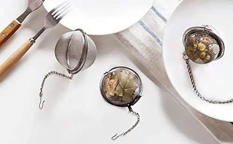 Two Pack 2.1 Inch Stainless Steel Mesh Tea Ball Infuser Strainer Filters For Teas Durable 304 Grade Tea Filter Basket on a dining table