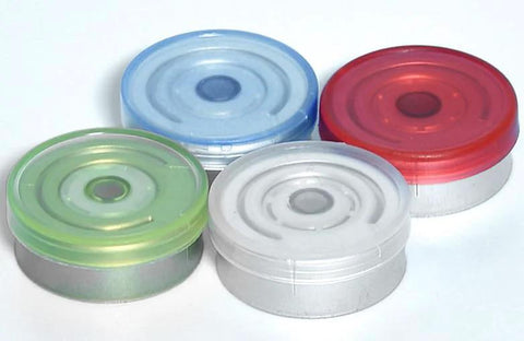 Four empty 10ml glass vials with aluminum flip-off caps in blue, green, white, and red