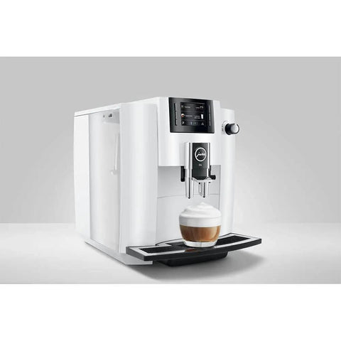 Straight Up Game Changer Automatic Espresso Coffee Maker With Easy Cappuccino Function And Premium Aroma Grinder In Sleek Piano White Finish pouring a latte.