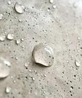 Close-up of water droplets on concrete surface treated with Concentrated Silane Siloxane Water Repellent For Concrete Brick And Masonry Surface Sealer Low Voc Penetrating Formula Big Time Protection That Holds Up Through Rough Days.