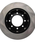 Rear brake rotor, front view; metal disc with black center hub and eight lug holes.