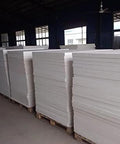 Ceramic fiber insulation board, 24x12x1 in, white; several boards stacked on pallets in a warehouse