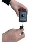 Hands holding variable speed 110V airflow controller for forge blower fan, showing dial settings for precise forge airflow control.