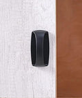 Close-up of 6 Pack Self Stick Cabinet Handles and Drawer Pulls With Adhesive, Drill Free Installation on a wooden surface in black.