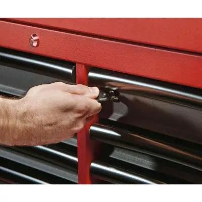 Person using a key to lock the Heavy Duty 16 Drawer Tool Chest And Rolling Cabinet Set 46 Inch Red Black for secure storage.