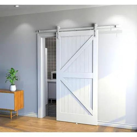 Heavy Duty Double Bypass Sliding Barn Door Hardware Kit With Low Profile Flat Track System gliding smoothly in a modern home.