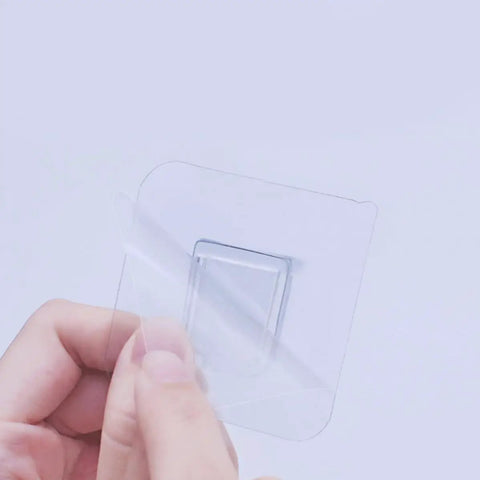 Close-up of 24 Pack ABS Shelf Brackets For Heavy Duty Shelves And Wall Racks with protective layer being removed by hand
