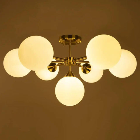 Gold Seven Light Glass Globe Sputnik Chandelier Pendant for Foyer Kitchen Dining Living Room Rustic Vintage Modern Metal Ceiling Fixture Semi Flush Mount Large Hanging Lamp with gold finish and frosted globes, illuminated against a dark background.
