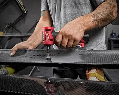 User operating the Top Shelf Brushless Right Angle Die Grinder 12V Cordless Powerhouse on a carbon fiber surface.