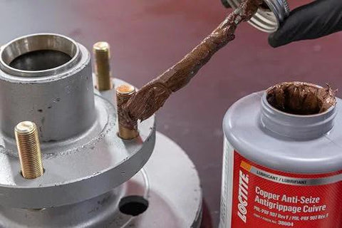 Applying Copper Anti-Seize Lubricant Workhorse Brush-Top Bottle 1 Lb High Temp Up To 1800F to metal threads to prevent seizing