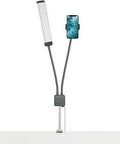 Capture Pro Kit Pro Grade LED Desk Light with Phone Holder for Creators, dual-arm design, clamp mount on table edge.