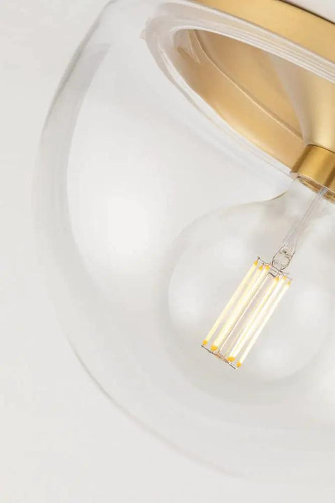 Close-up of Grace 1 Flush Mount Ceiling Light in Aged Brass Finish with Clear Glass, 10 Inch Wide by 7 Inch High, Classic Yet Modern Incandescent