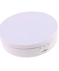 Luxury Electric Rotating Jewelry Display Stand With Mirrored Base, Smooth Spin Turntable For Rings, Necklaces & Watches, ABS Build, High Speed Rotation Showcase Organizer Box top view of the round white ABS base with control buttons.