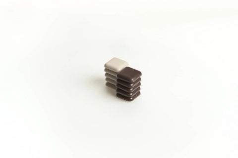 Stack of brown and beige 1-Inch Square Self-Stick Furniture Sliders For Carpet Protect Your Furniture And Move Effortlessly