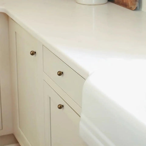 Kitchen cabinet with 10 Pack Antique Brass Cabinet Knobs 0.9 Inch Round Solid Zinc Alloy Vintage Dresser Drawer Pulls installed.