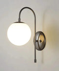 Upgrade Your Vibe With Sleek Brass Wall Sconces Featuring Handcrafted White Glass Globe Shades Ideal For Modern Farmhouse And Bedroom Lighting E27 Socket wall sconce with curved arm and white globe.