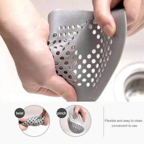 A Total Game Changer 3 Pack Silicone Drain Catchers For Sink And Tub Reusable Hair Strainers shown in gray, flexible material being rinsed.