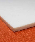Sheet Three Sixteenth Inch Thick By Twelve By Twenty Four Inches Of PTFE for nonstick surfaces and chemical resistant use, shown with coin for scale