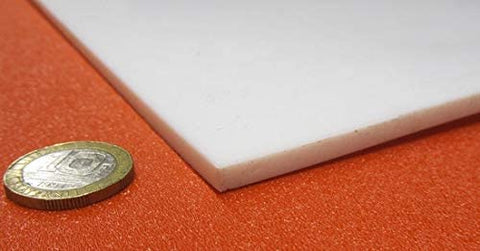 Sheet Three Sixteenth Inch Thick By Twelve By Twenty Four Inches Of PTFE for nonstick surfaces and chemical resistant use, shown with coin for scale