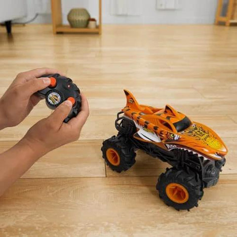 Monster Trucks RC Tiger Shark One Twenty Four Scale Remote Control Truck with Terrain Action Tires on wooden floor