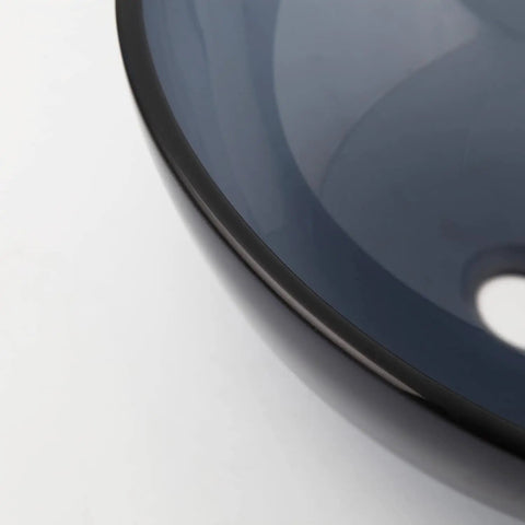 Close-up of the Dope Gray Round Glass Vessel Sink With Waterfall Faucet And Pop Up Drain Above Counter Bathroom Vanity Basin