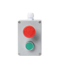 Metal electrical push-button control box with red emergency-stop knob and green start button.