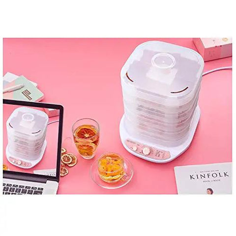 Slick Digital Food Dehydrator Featuring Five Stackable Trays Adjustable Heat Control Plus Solid Forty Eight Hour Timer on a pink table.