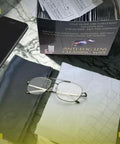 Front view of TOVO PRIME anti-fog eyeglasses cleaning wipes box with microfiber lens cloth, glasses and smartphone.