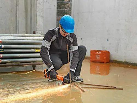 Person using the Beast Mode 18V Cordless Angle Grinder for cutting metal on a construction site, wearing safety gear.