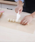 Person using Five Pack Teflon Baking Sheets 12x16 Inch Nonstick Reusable Liners to mold dough, showcasing versatility for DIY projects.