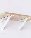 White Heavy Duty L Shaped Shelf Bracket Rock Solid Wall Mount No Worries Install Rust Free Iron Corner Support For Bookcases Room Divider High Gloss White Finish supporting a wooden shelf.