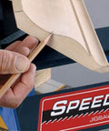 Speed Cope Crown Molding Jig With Adjustable Handle for DIY Woodworking in use, creating precise cope cuts on wood molding.