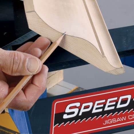 Speed Cope Crown Molding Jig With Adjustable Handle for DIY Woodworking in use, creating precise cope cuts on wood molding.